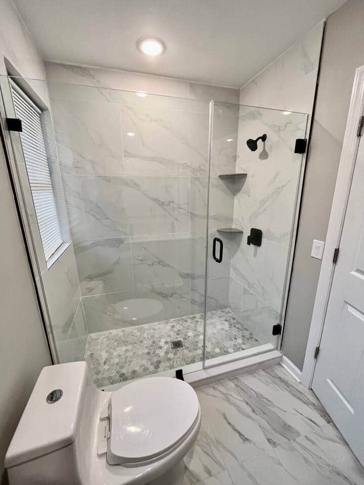 Large Tile Shower with glass sliding doors.