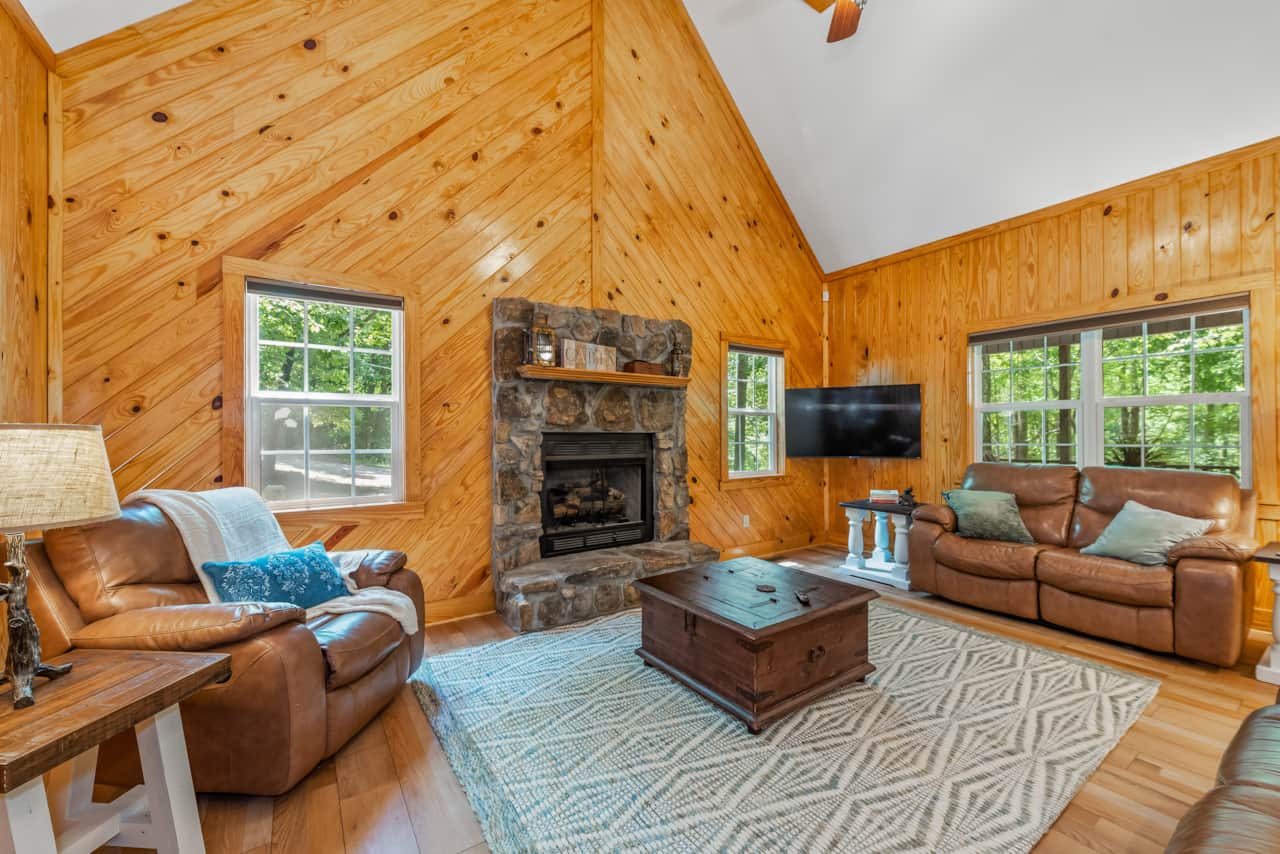 Spacious living room features gas fireplace, smart tv, and reading nook.