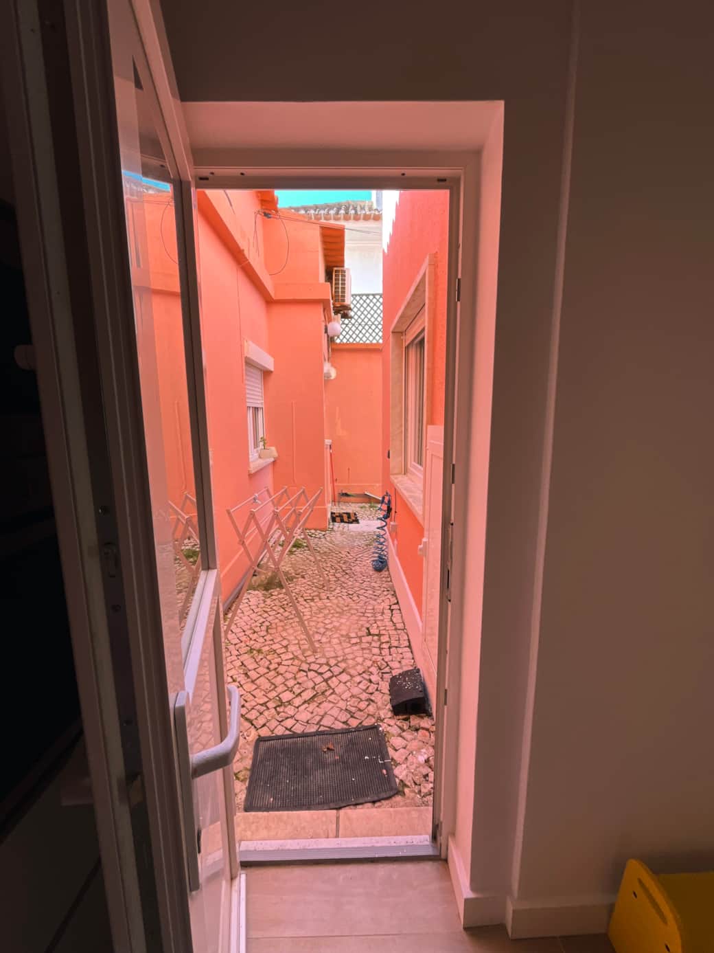 Outside corridor with shower tap and drying rack