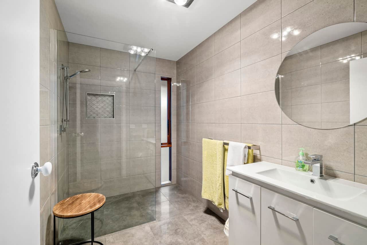 Newly renovated bathroom with sleek walk-in shower.