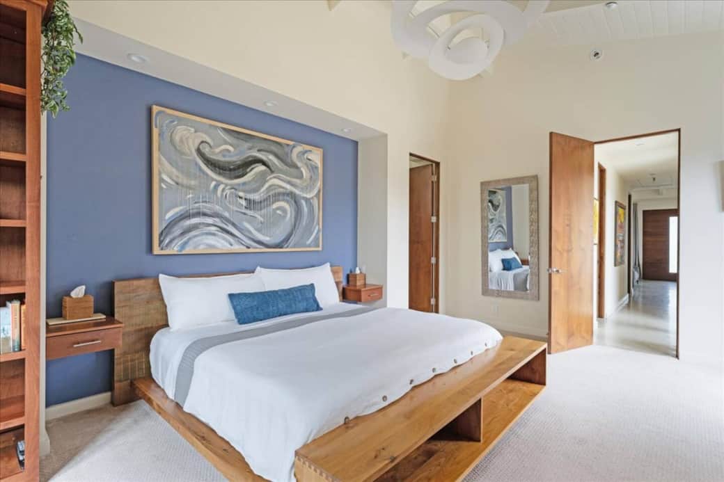 Spacious primary bedroom suite with king sized bed, and plush linens.