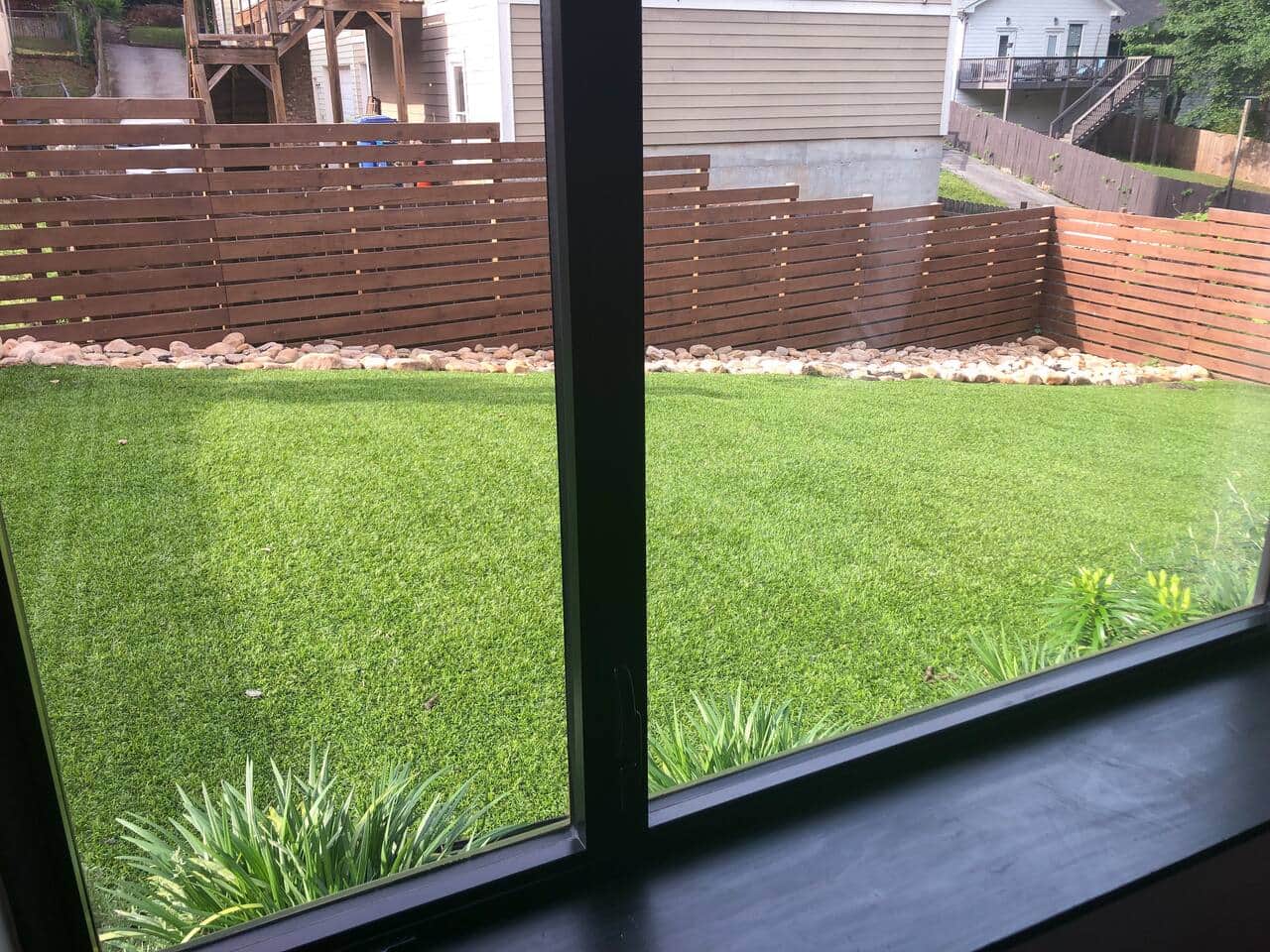 view of the fenced-in backyard from the living room