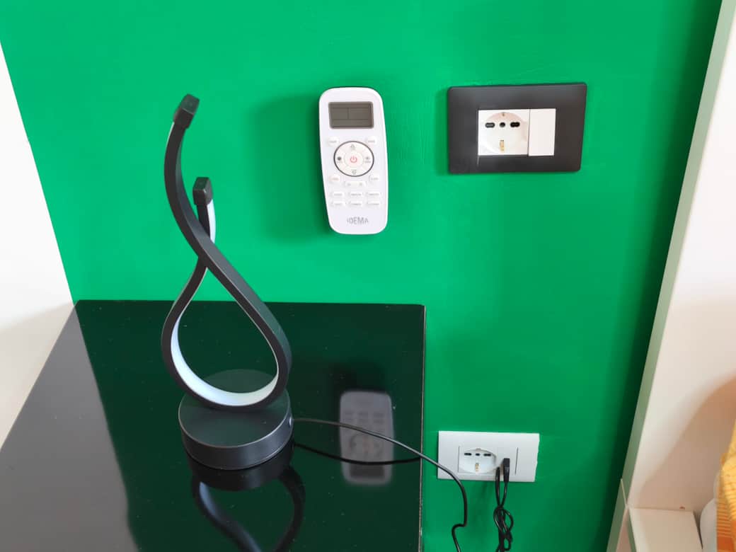 Bedside tables with German power outlets and adjustable LED lamps in Agli Archi Eco House