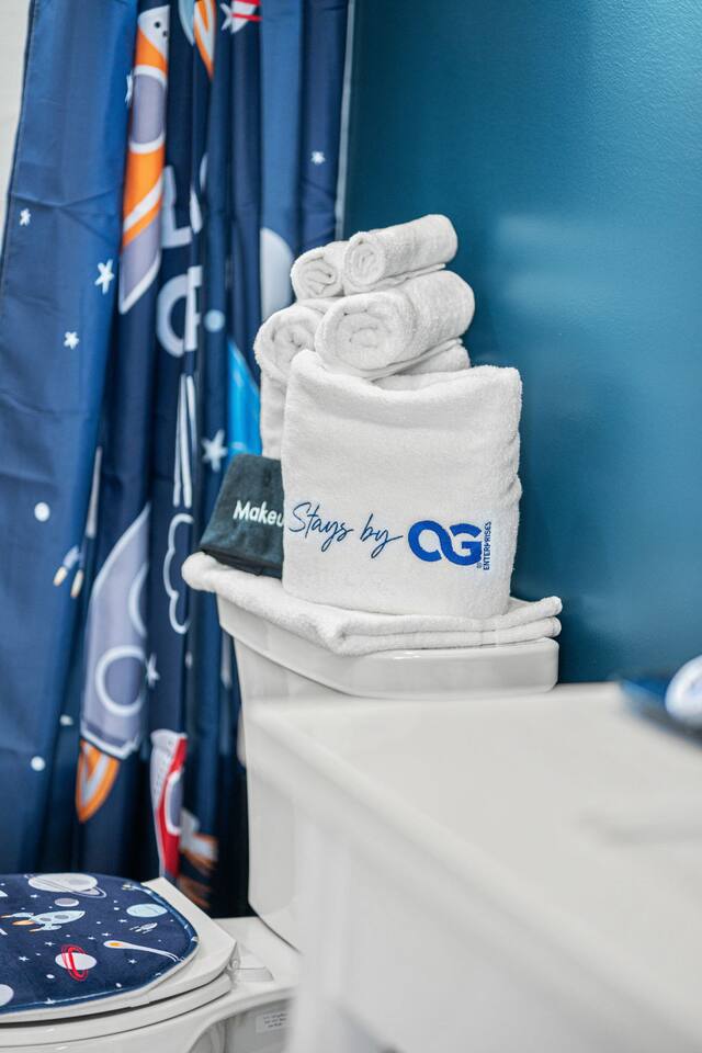 Fluffy towels and thoughtful touches set the tone for a refreshing bathroom experience.