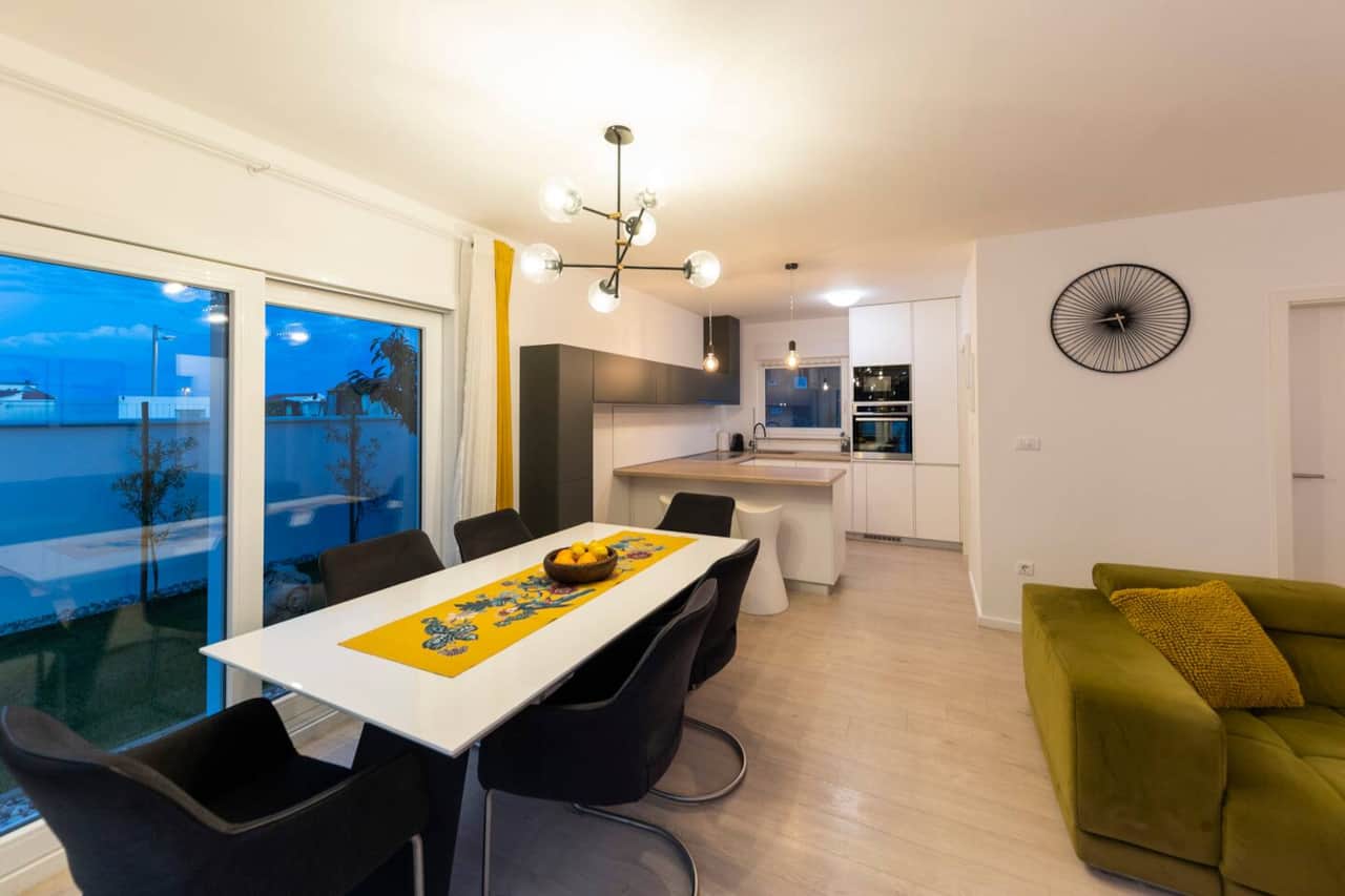 Dining table for 8 and open-plan kitchen in the villa