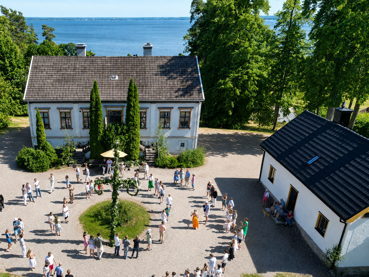 Flemma Gård manor house during a traditional summer gathering