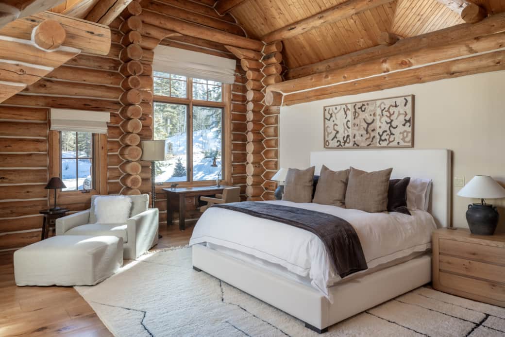 Primary suite with king bed, seating, open layout and work desk