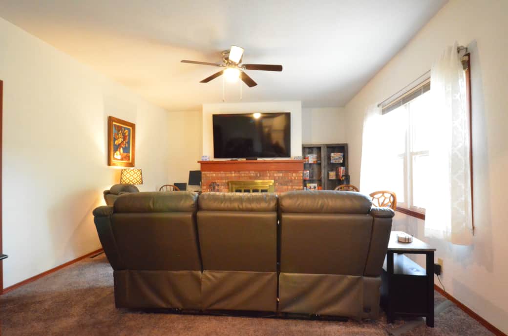 Family Room with a large Roku TV, a work area with a monitor and power, plenty  seating and games.