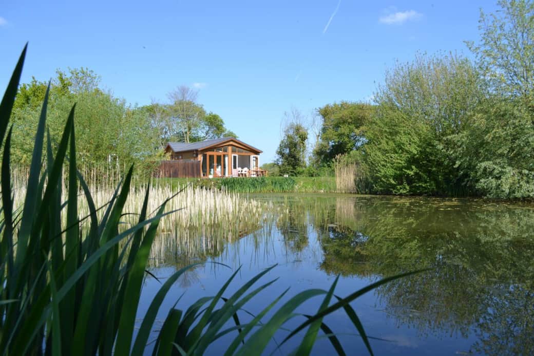 A view of Oak lodge which overlooks one of our fishing lakes at Welhams Meadow. 