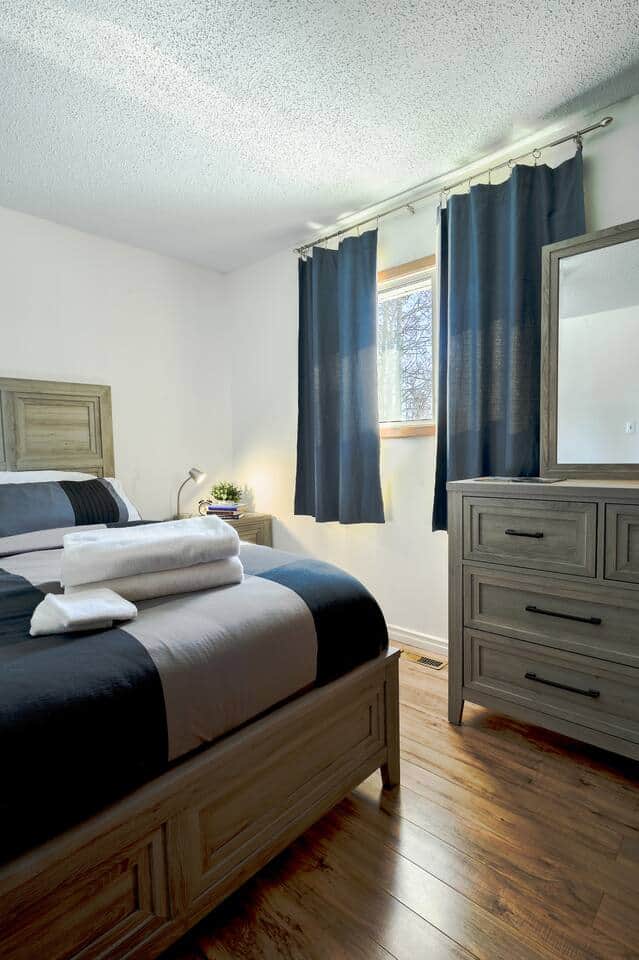 Comfortable & Serene BedroomRelax in a cozy bedroom with a plush bed, soft linens, and a calming ambiance. Large windows bring in natural light, while minimalist decor ensures a peaceful stay. Perfect for a restful night’s sleep!