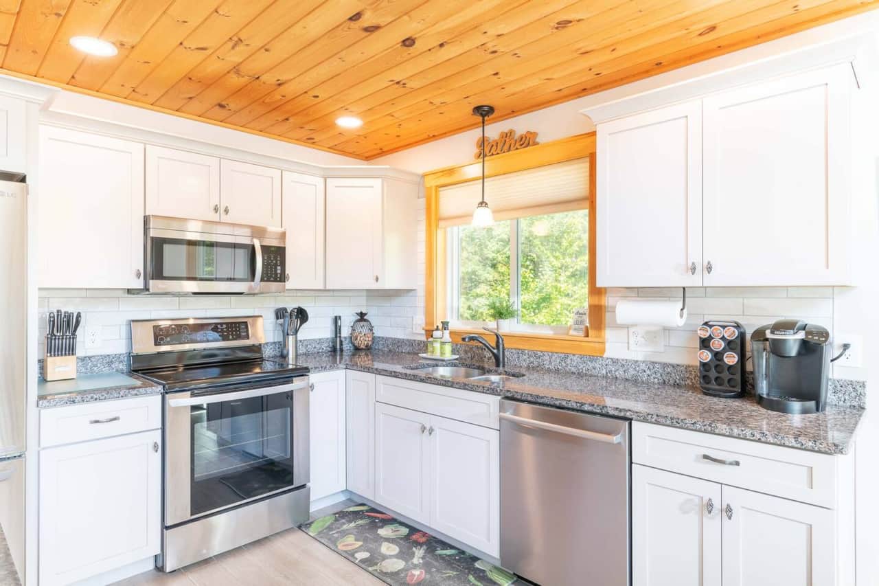 Fully stocked kitchen with stainless appliances and granite countertops