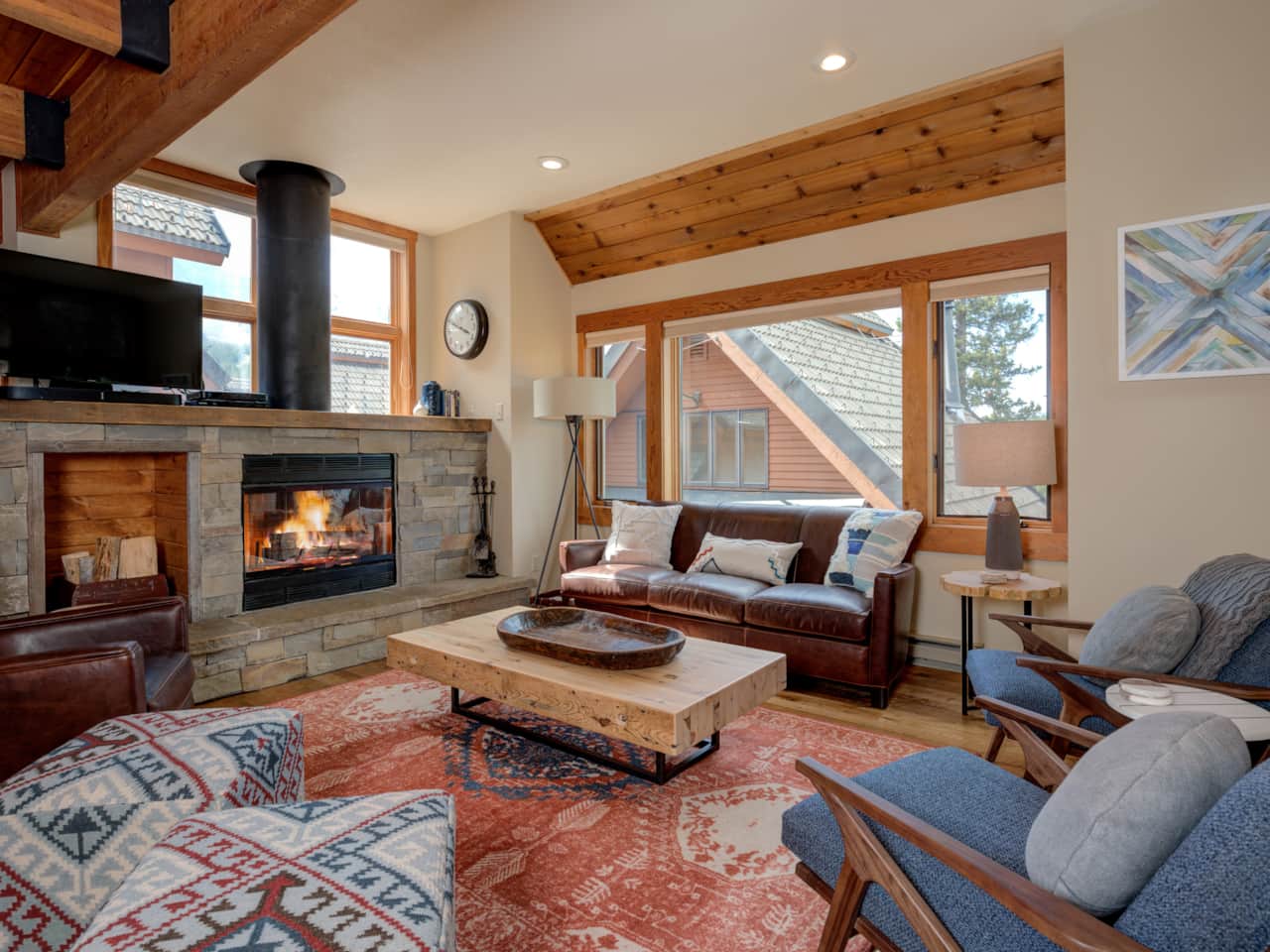Big Sky vacation rentals cozy living room with real wood fireplace, firewood provided