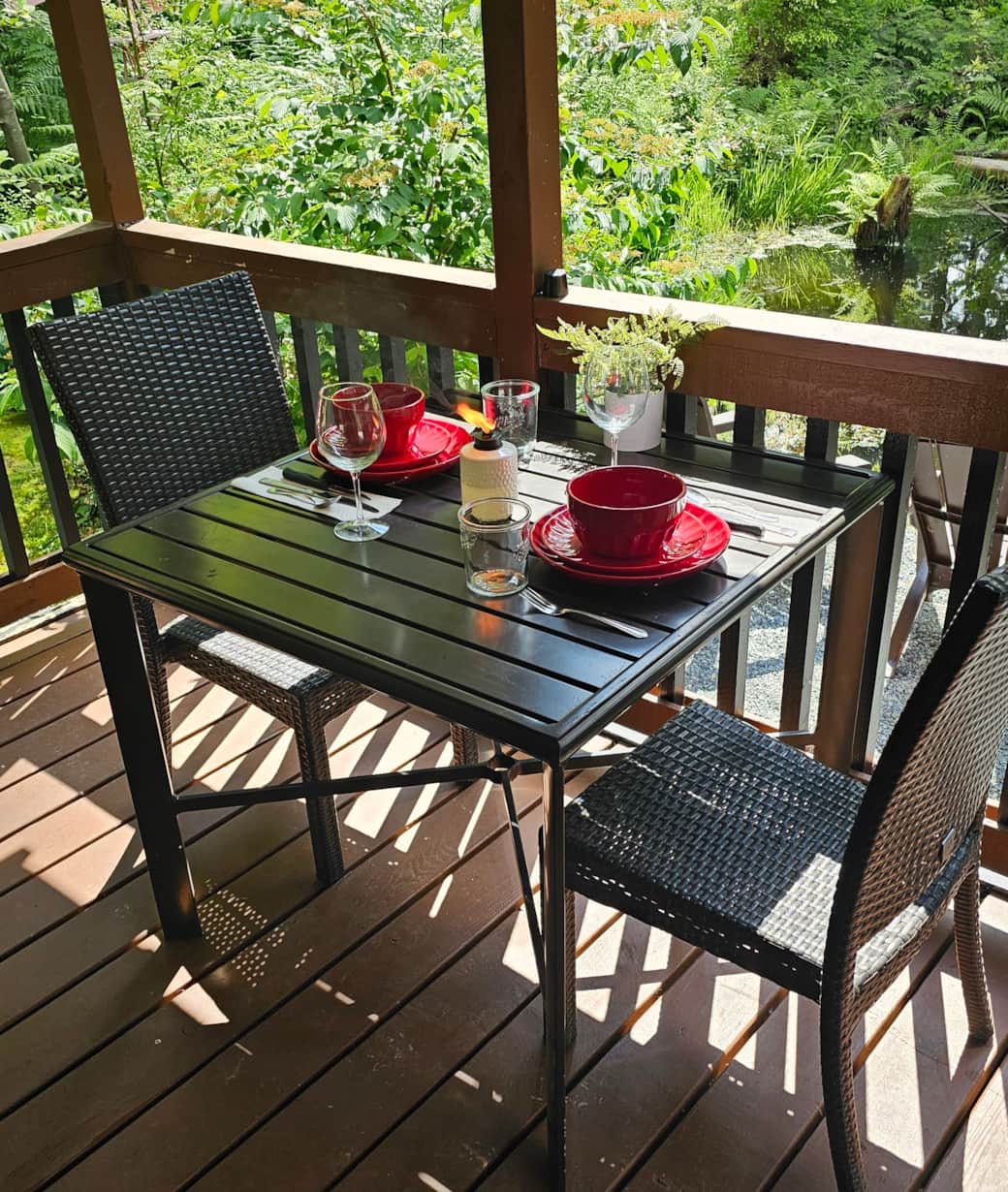 Enjoy a dinner on the porch. With seating for two over looking the pond.