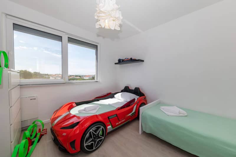 Children's room with a red race-car bed