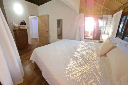 Bedroom with ocean views through large windows Bedroom with ocean views through large windows