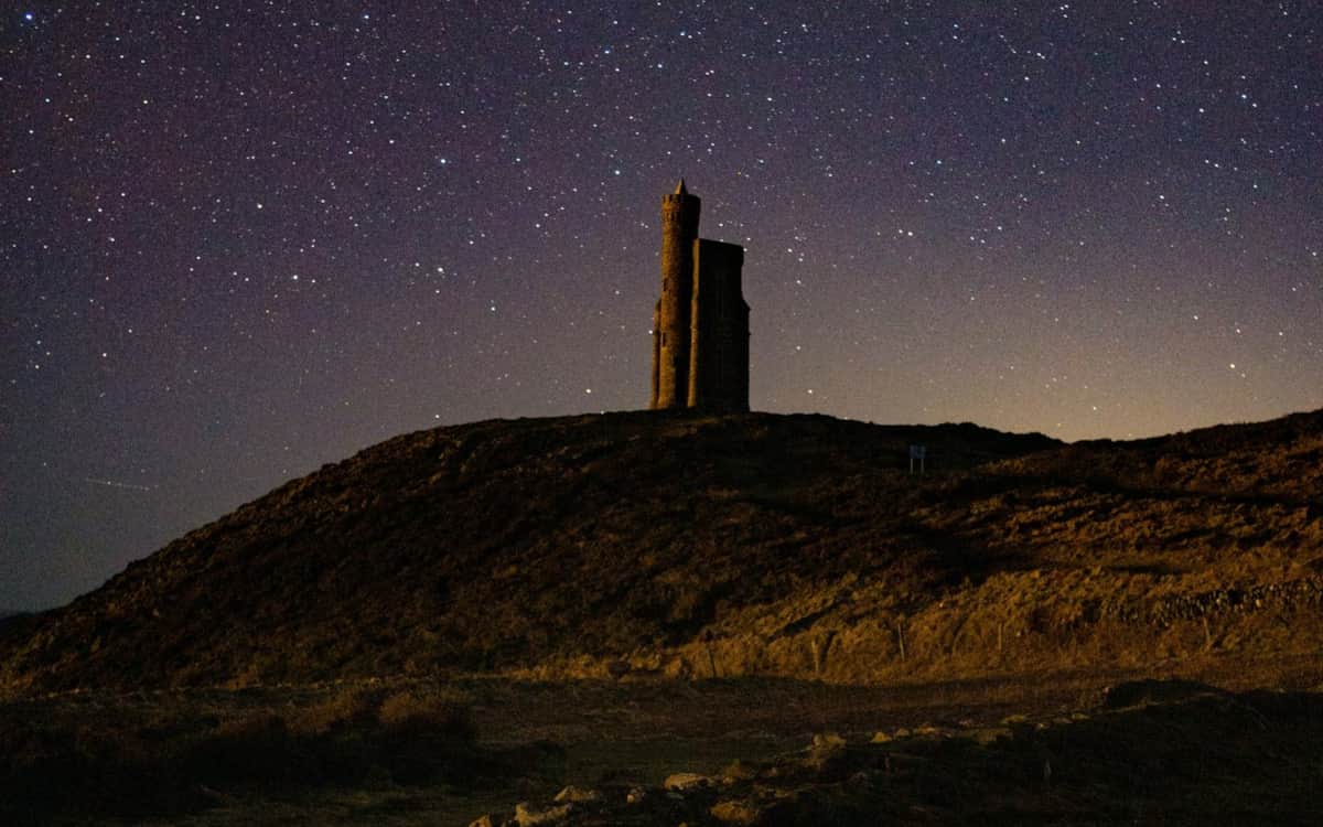 Milner's Tower under a night sky full of stars