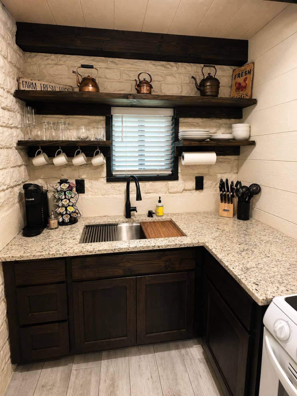 Fully stocked kitchen featuring modern essentials, open shelving, and convenient coffee station