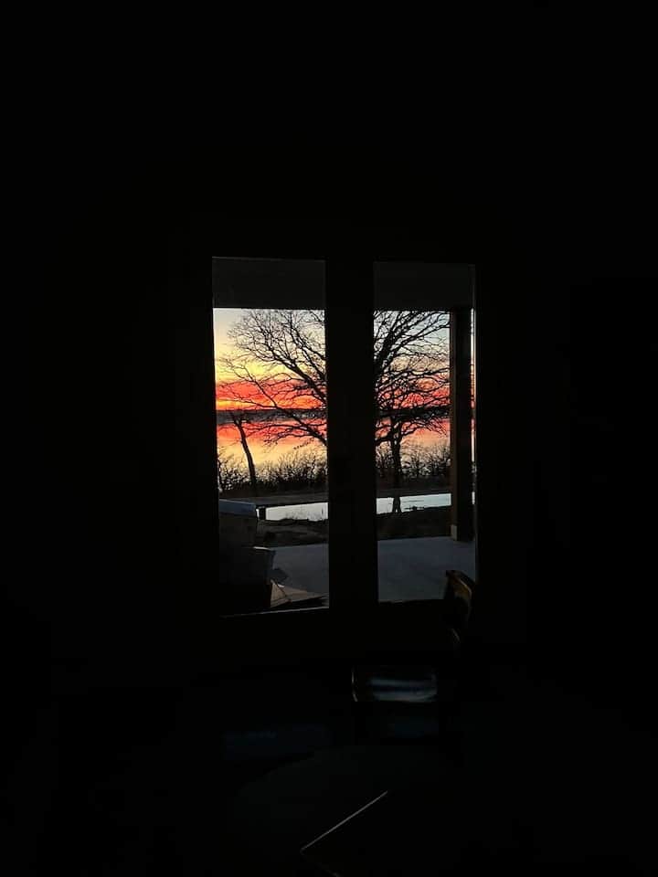 Wide French Doors provide beautiful lake and sunset views no matter the weather with direct access to the patio when the outdoors is calling you.