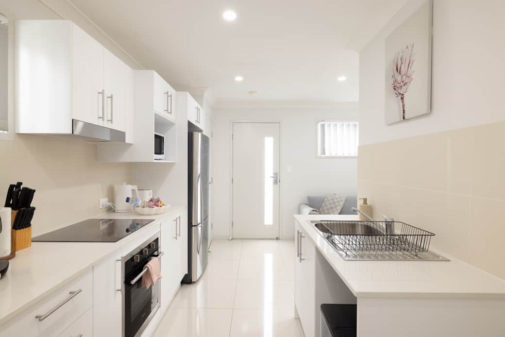 Kitchen: Sleek kitchen with ample storage, modern appliances 