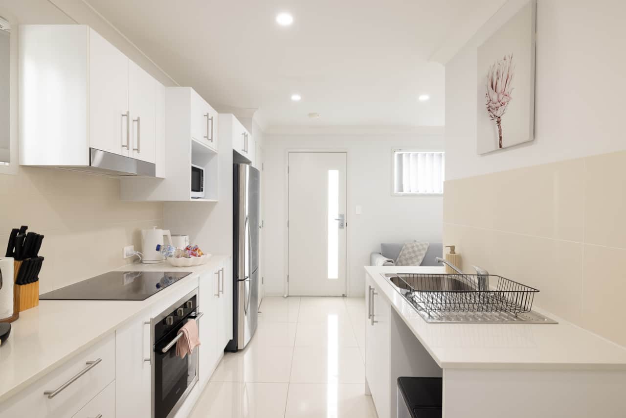 Kitchen: Sleek kitchen with ample storage, modern appliances 