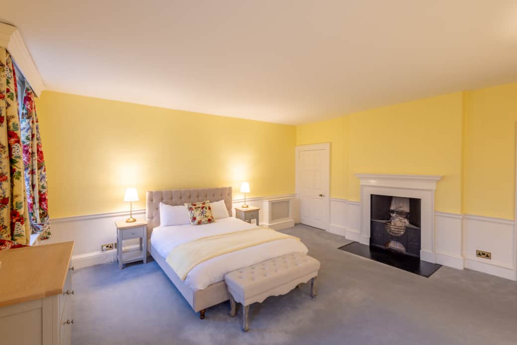 Old Rectory, bedroom 3, view of fireplace & king size bed