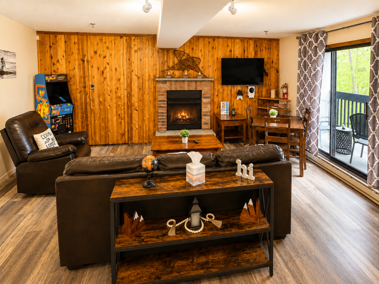 Spacious living room with arcade, sofa, recliner and smart TV with xbox