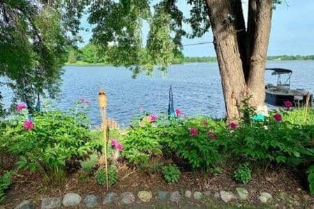 From the backyard over looking the sitting & fire pit landscaping looking out at the lake From the backyard over looking the sitting & fire pit landscaping looking out at the lake