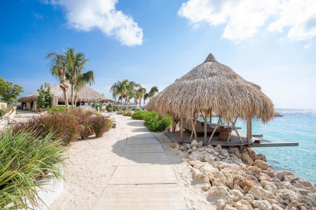 Path to the pier and Brass Boer - palapas for rent, served on site. Main beach chairs free!