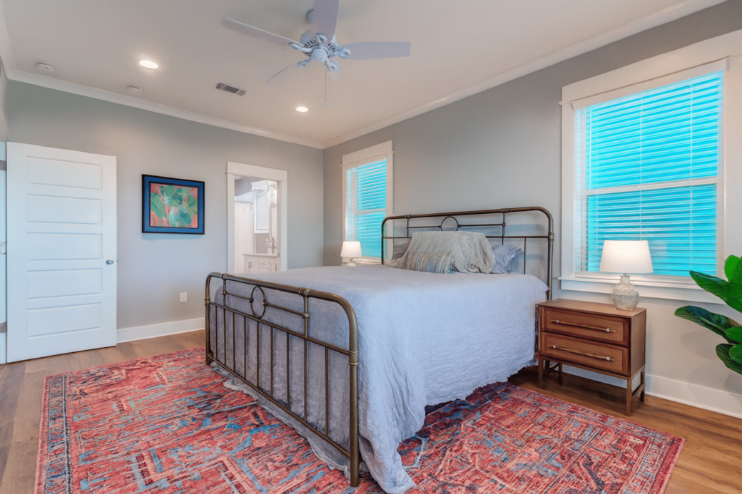 Peaceful master suite with soft bedding and great natural light