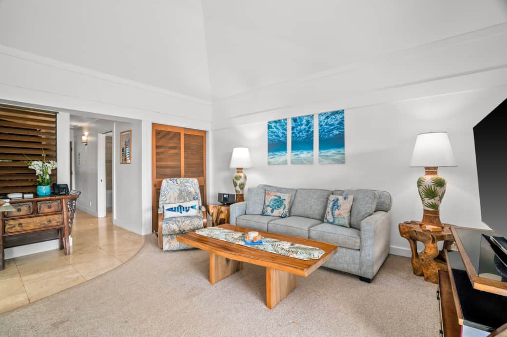 Sunlit living opens to the lanai; smart TV, ceiling fan, and dining for four— comfy retreat
