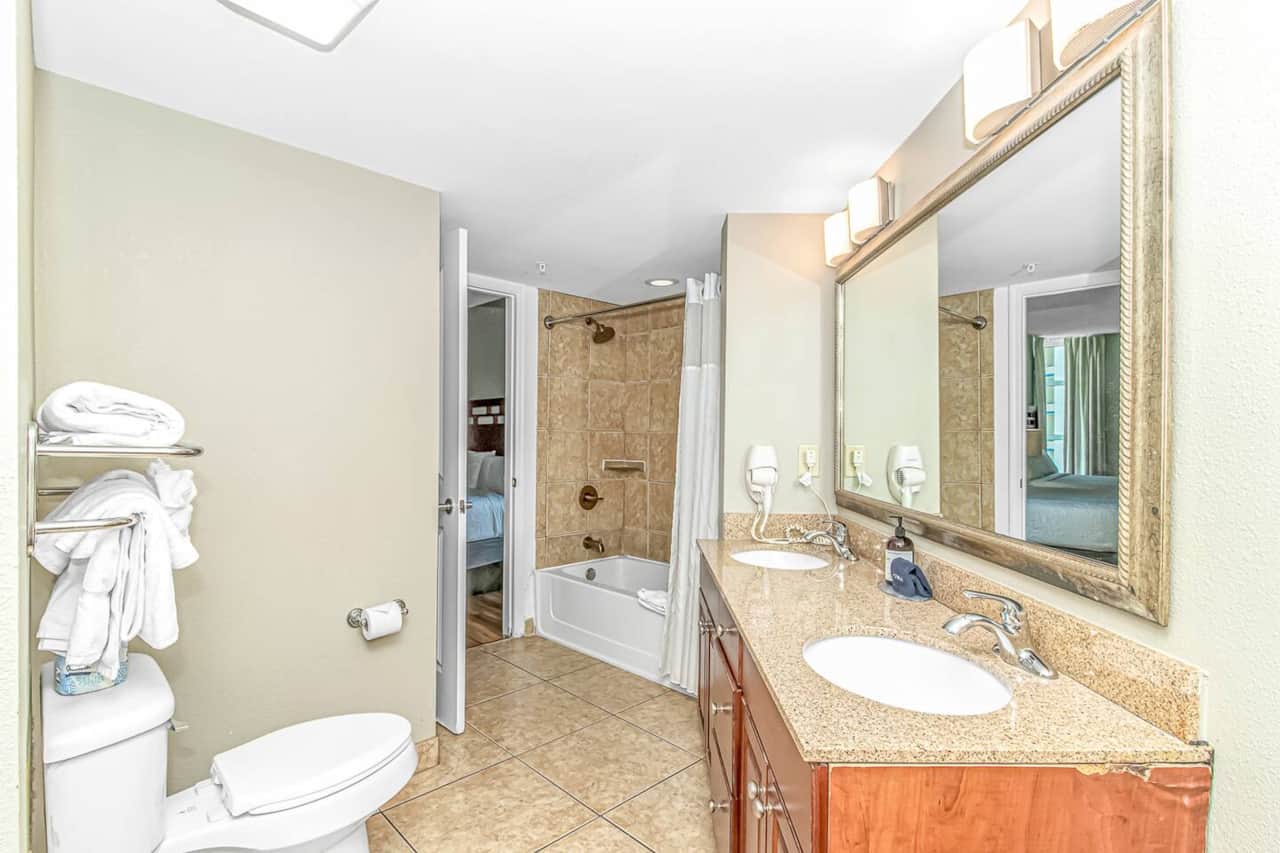 Spacious bathroom with double sinks and a shower/tub combo. Entry from bedroom or hallway off of the kitchen/living room. 
