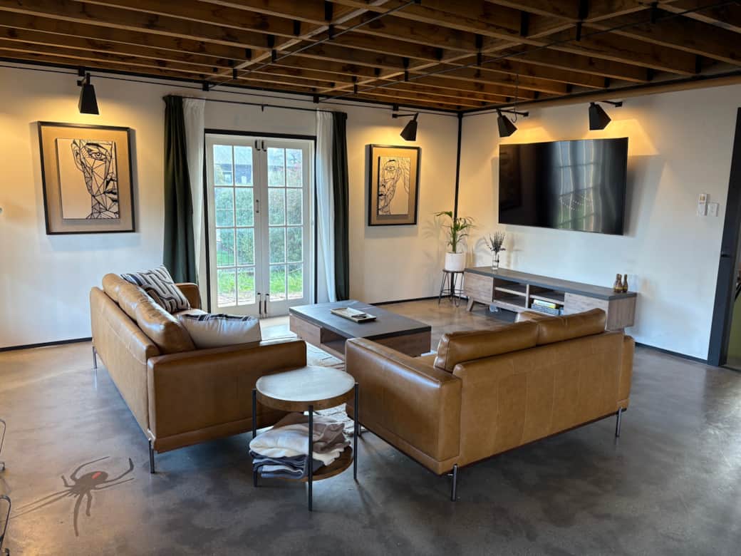 Open-plan living & dining area with comfortable seating and smart TV.