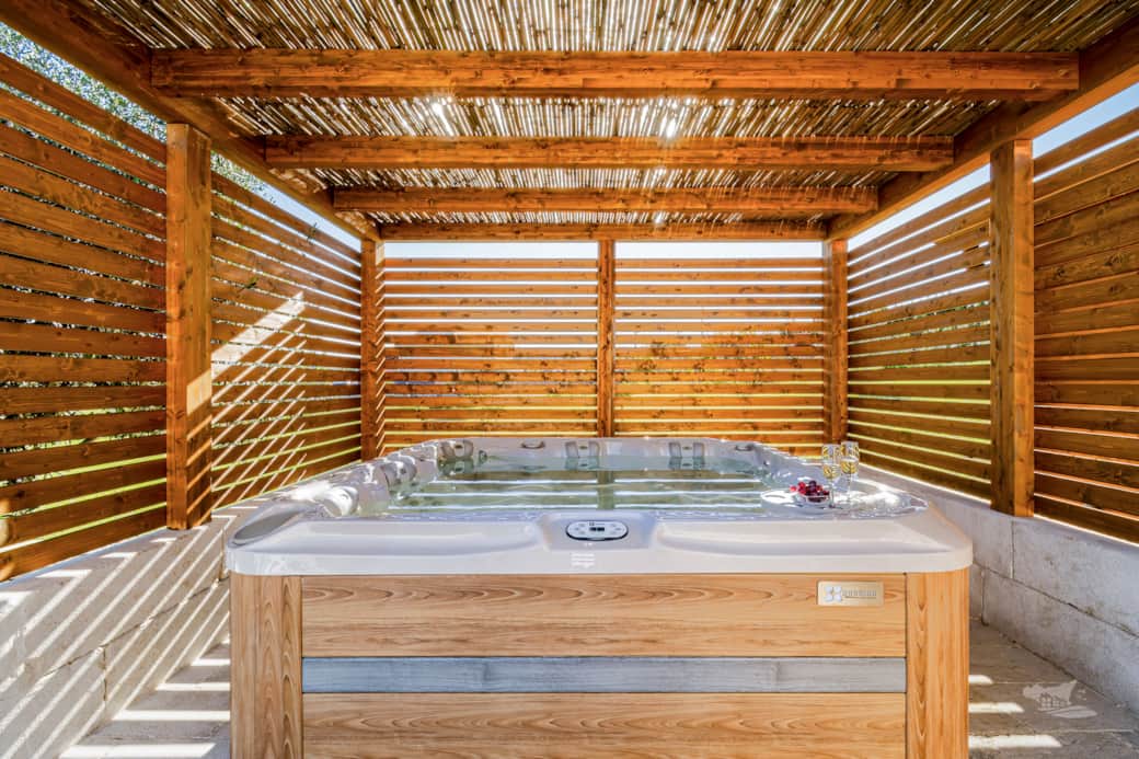 Relax in the private hot tub, sheltered under a stylish wooden pergola.