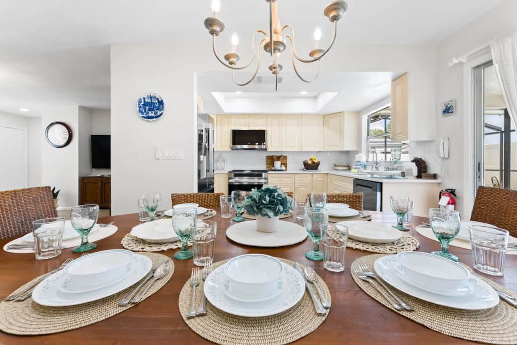 Gather around the spacious dining table, thoughtfully set to comfortably seat up to eight guests. 