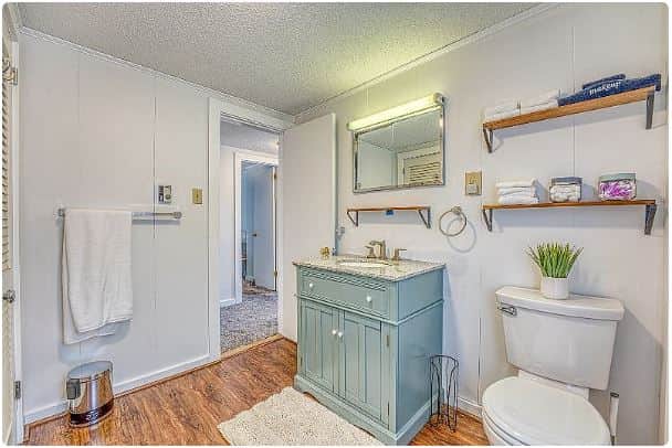 With a linen closet brimming with thirsty towels, the spotless bathroom features a shower over tub, commode and space for guest toiletries. 