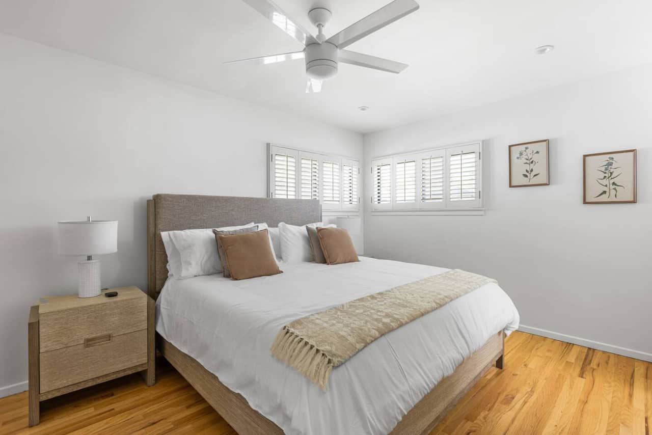 A spacious primary bedroom with a king size bed. 