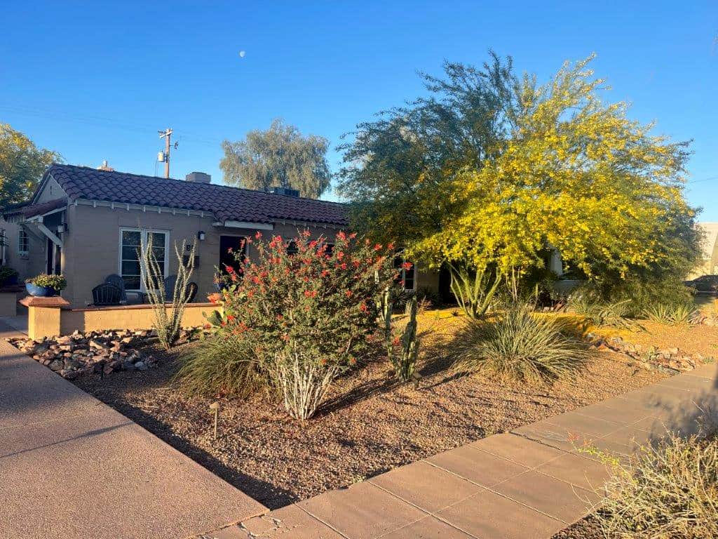 Front of charming home from the driveway featuring many Arizona native plants. Front of charming home from the driveway featuring many Arizona native plants.