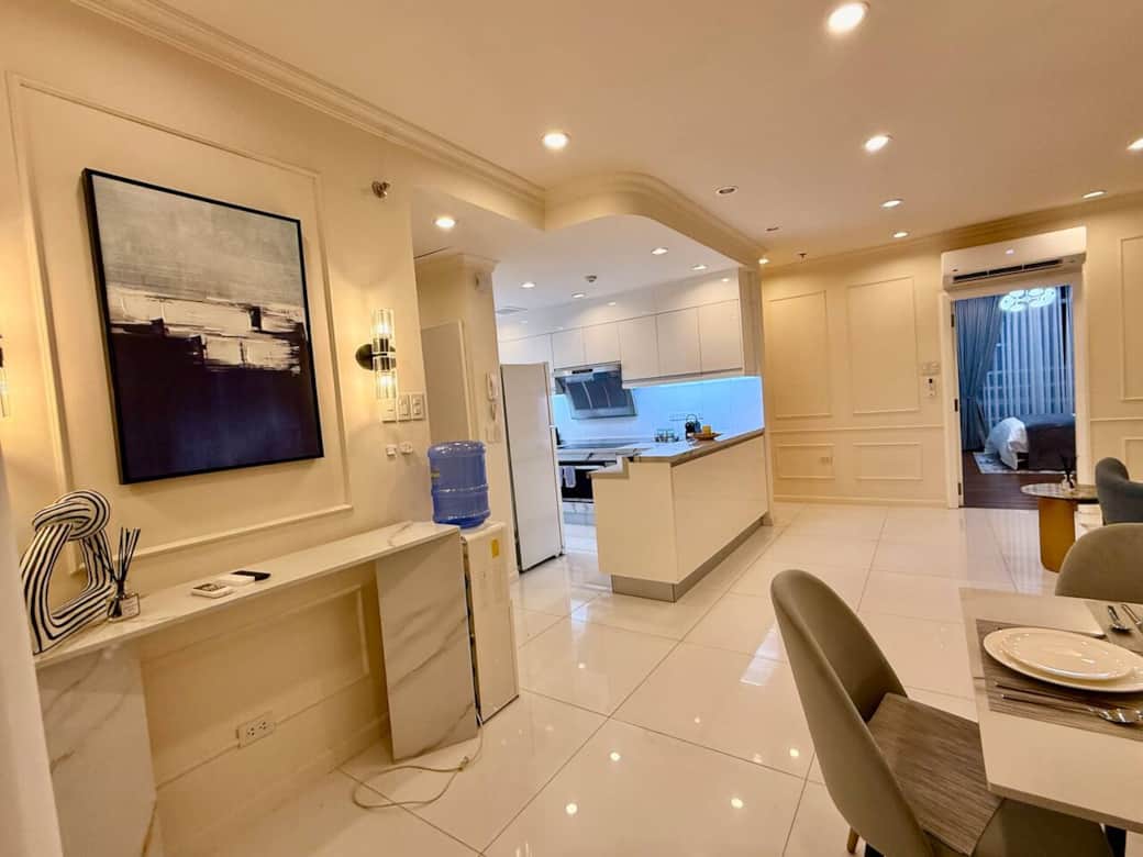 A cozy and open lay out kitchen with everything you need—pots, pans, plates, glasses, appliances, and utensils—for cooking and enjoying your meals.