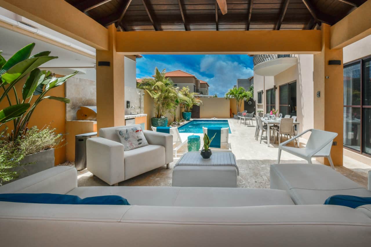 View of the backyard from under the gazebo-covered lounging area