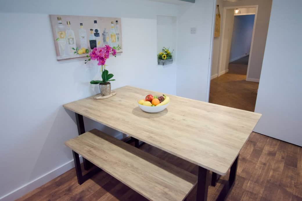 A simple, spacious dining area perfect for morning coffee, family meals, or planning your next Peak District adventure.