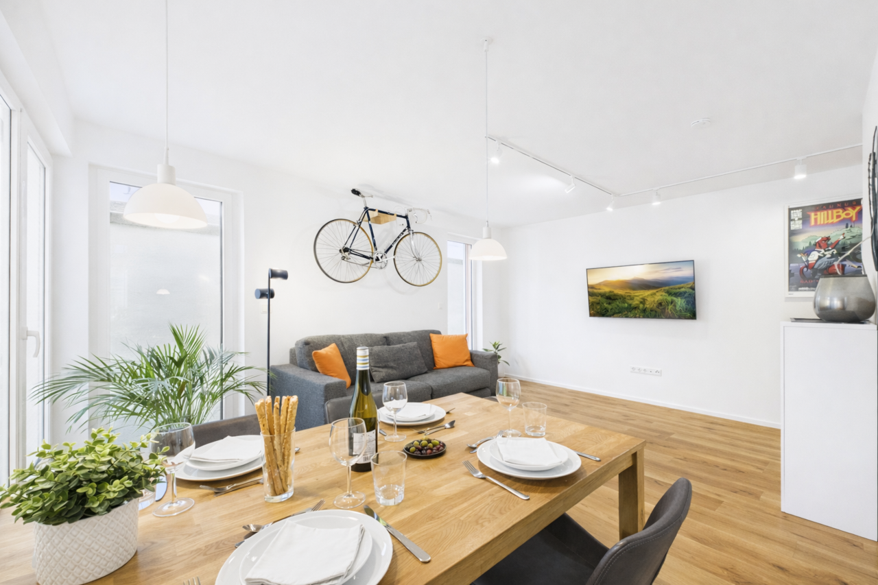 Spacious, open-plan living and dining area with a cozy sofa bed (160 × 200).