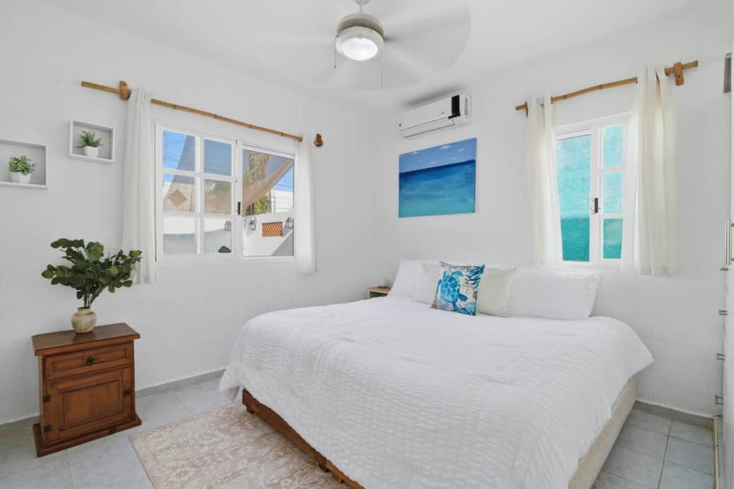 Unwind in this cozy bedroom featuring a comfortable king-size bed with plush pillows, AC, and a ceiling fan for a perfect night’s sleep.