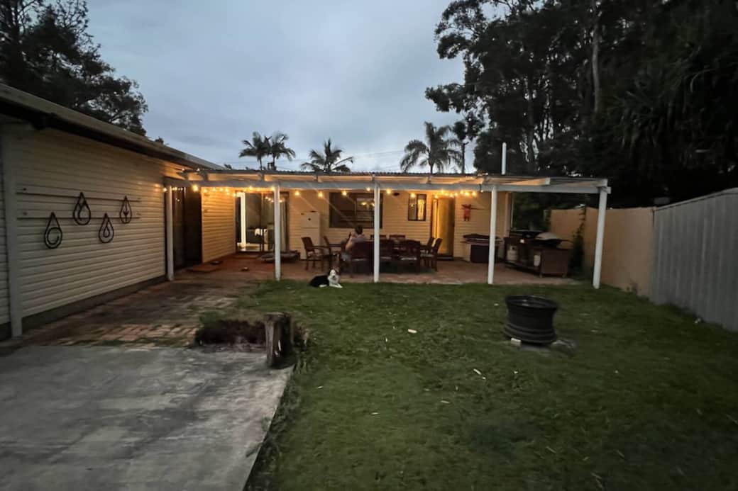 Looking back at the covered outside BBQ and entertainment area at dusk.