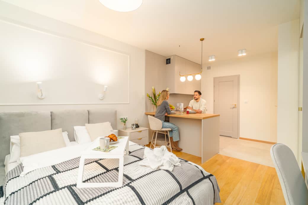 A cozy studio with a sleeping area and a kitchenette.