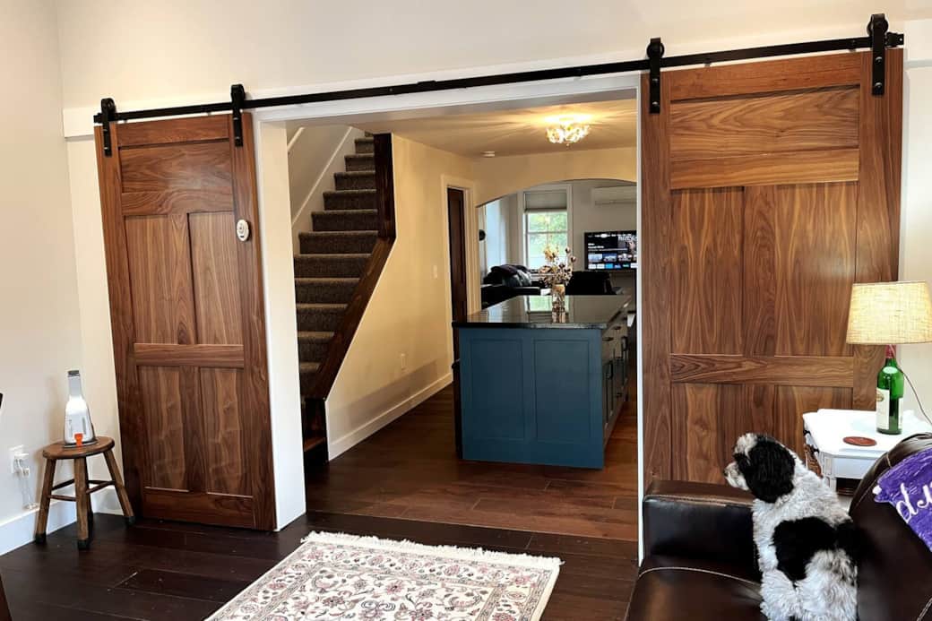 A charming family room with custom barn doors connects the back deck to the kitchen.