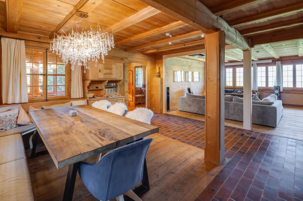 Large dining room with a cozy fireplace and massive oak table, seating 10 people.