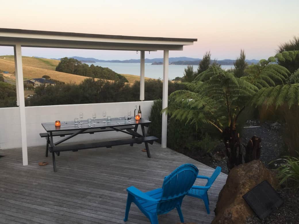 Outdoor dining table with stunning views over the Bay of Islands at Wharau Lodge, Kerikeri.