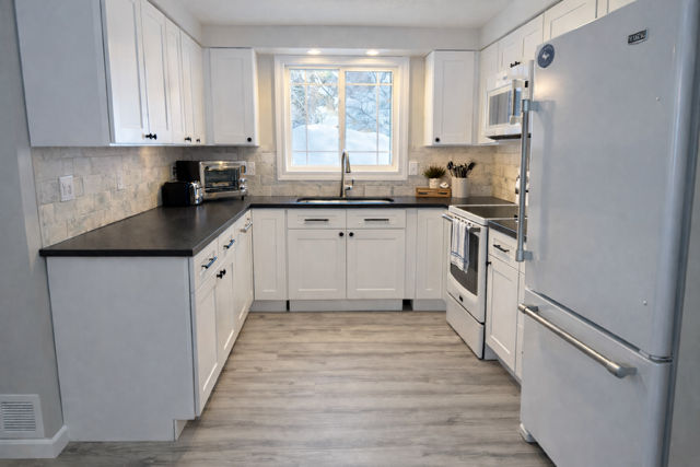 Fully equipped kitchen with modern appliances and generous prep space.