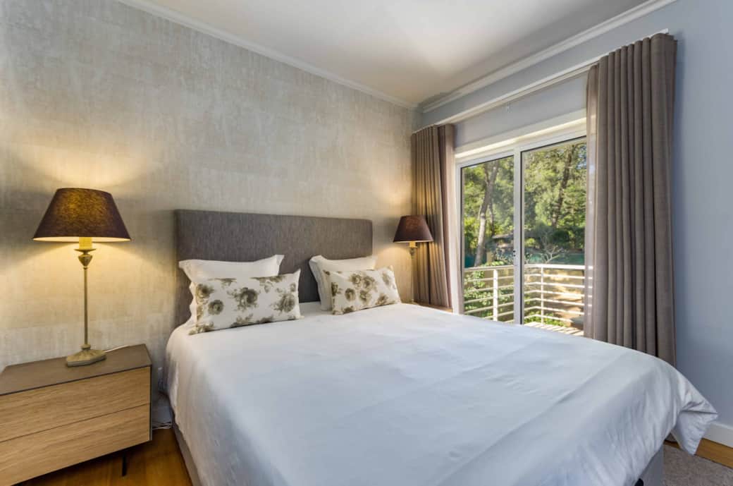 Suite 2 Elegant queen-size bedroom with balcony  and garden & pool views