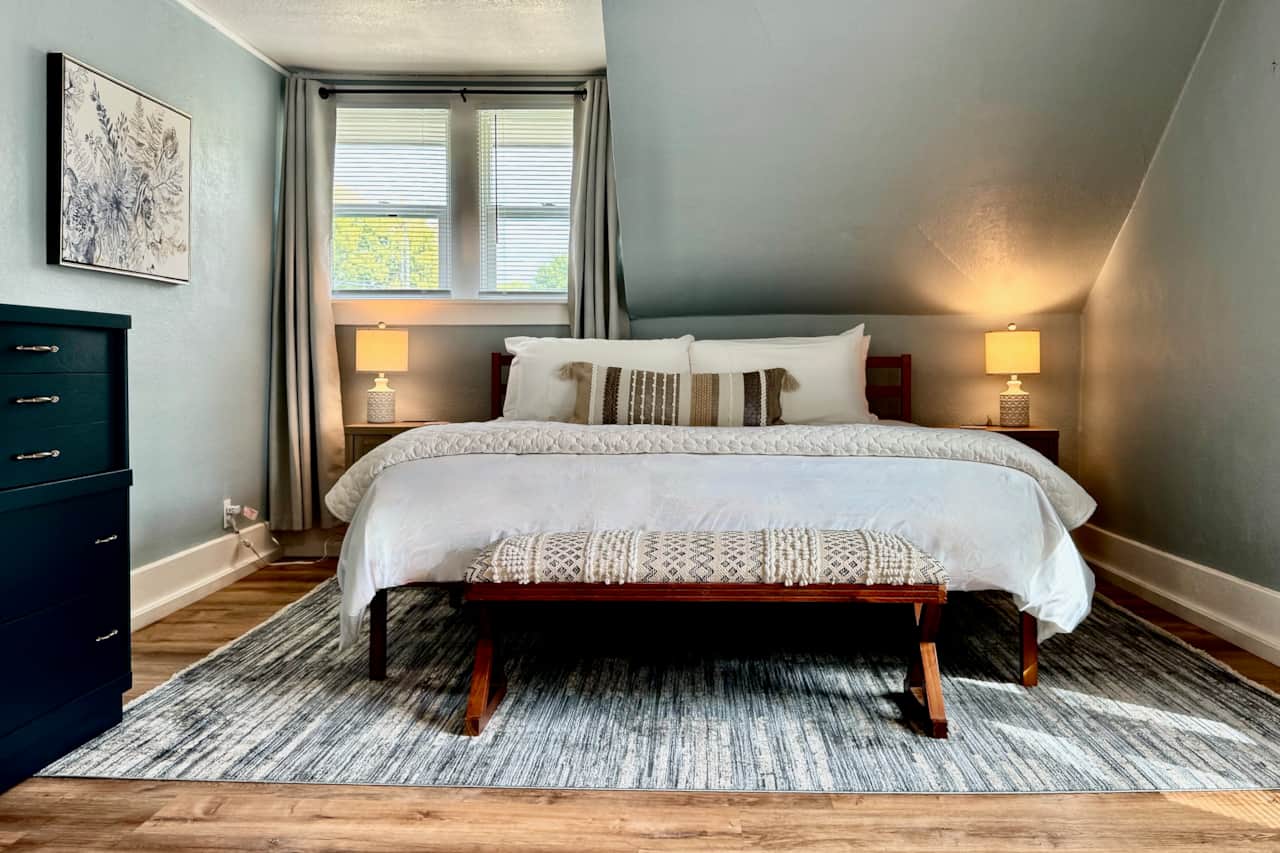King Helix Midnight mattress, blackout curtains and premium linens in Bedroom 1.
